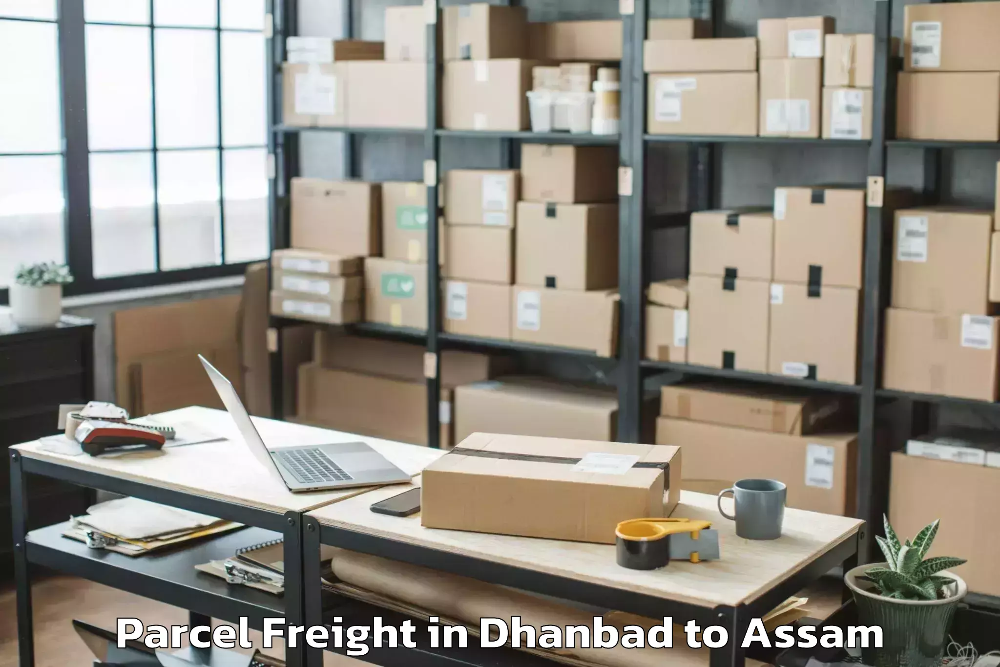 Professional Dhanbad to Rajakhat Banekuchi Parcel Freight